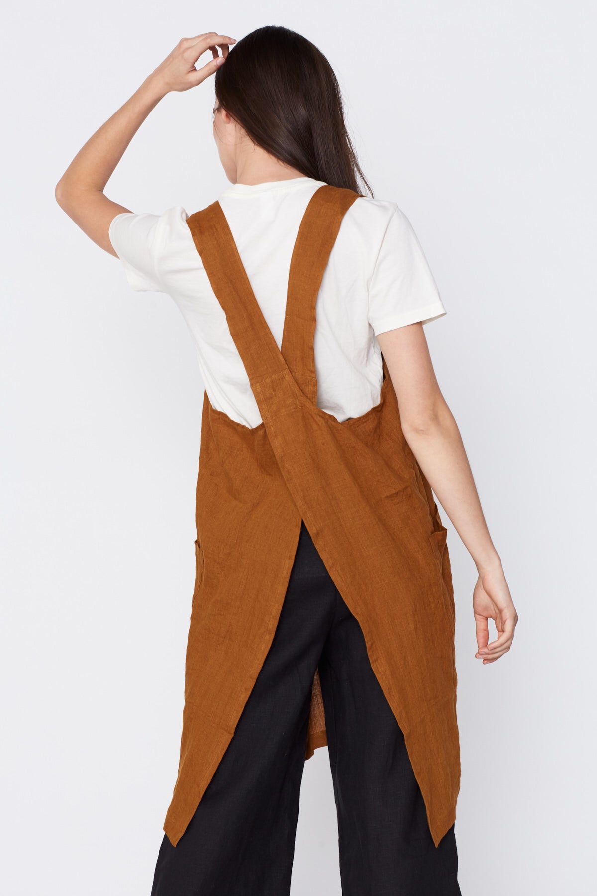 Linen Pinafore Apron in Ocre. Made in Atlanta, ethically and sustainably, by slow fashion designer Megan Huntz. 